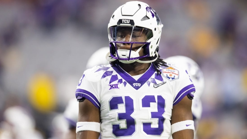 Dec 31, 2022; Glendale, Arizona, USA; TCU Horned Frogs running back Kendre Miller (33) against the Michigan Wolverines during the 2022 Fiesta Bowl at State Farm Stadium. Mandatory Credit: Mark J. Rebilas-USA TODAY Sports