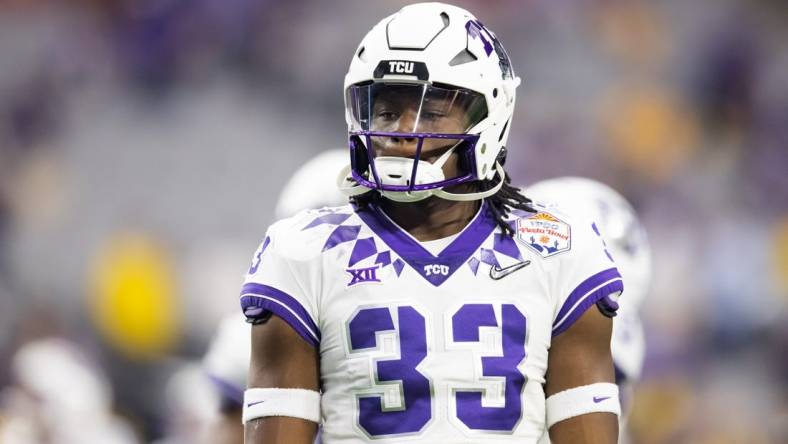 Dec 31, 2022; Glendale, Arizona, USA; TCU Horned Frogs running back Kendre Miller (33) against the Michigan Wolverines during the 2022 Fiesta Bowl at State Farm Stadium. Mandatory Credit: Mark J. Rebilas-USA TODAY Sports