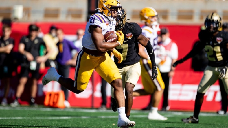 Jan 2, 2023; Orlando, FL, USA; LSU Tigers running back Noah Cain (21) rushes for a touchdown during the first half against the Purdue Boilermakers at Camping World Stadium. Mandatory Credit: Matt Pendleton-USA TODAY Sports