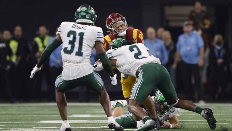 Jan 2, 2023; Arlington, Texas, USA; USC Trojans wide receiver Kyle Ford (81) is tackled by Tulane Green Wave linebacker Dorian Williams (2) in the second quarter in the 2023 Cotton Bowl at AT&T Stadium. Mandatory Credit: Tim Heitman-USA TODAY Sports