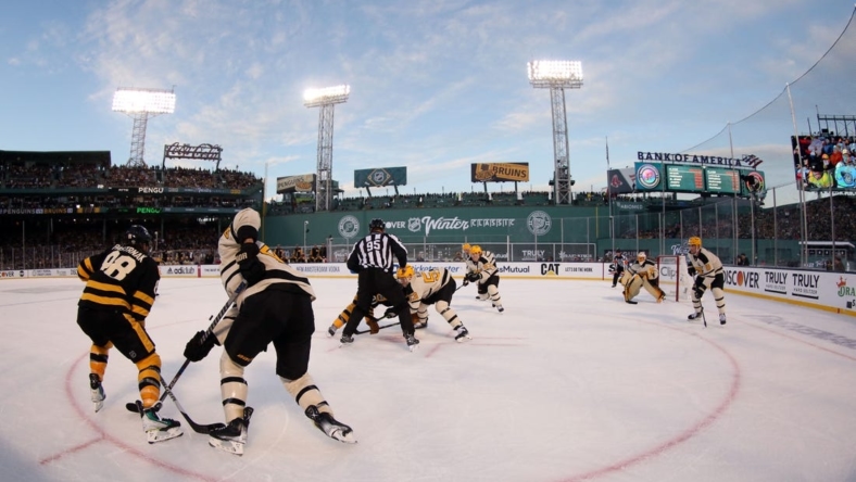 Jan 2, 2023; Boston, Massachusetts, USA; A face-off between the Boston Bruins and the Pittsburgh Penguins during the second period of the 2023 Winter Classic ice hockey game at Fenway Park. Mandatory Credit: Paul Rutherford-USA TODAY Sports