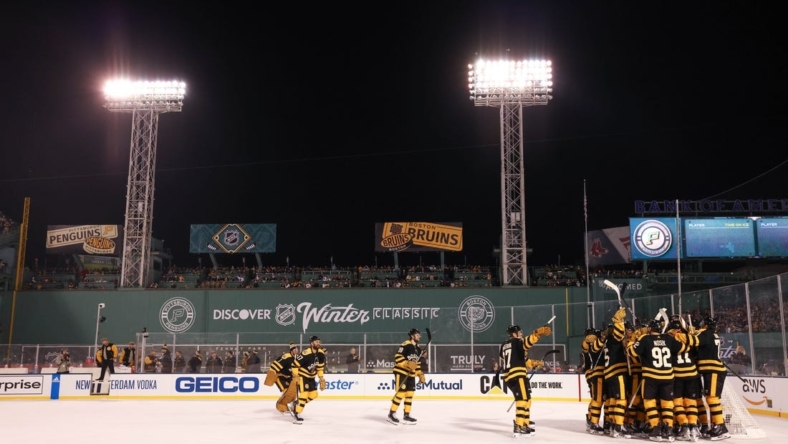 Jan 2, 2023; Boston, Massachusetts, USA; The Boston Bruins celebrate after defeating the Pittsburgh Penguins during the 2023 Winter Classic ice hockey game at Fenway Park. Mandatory Credit: Paul Rutherford-USA TODAY Sports