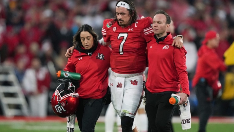 Jan 2, 2023; Pasadena, California, USA; Utah Utes quarterback Cameron Rising (7) walks with assistance off the field in the second half against the Penn State Nittany Lions of the 109th Rose Bowl game at the Rose Bowl. Mandatory Credit: Kirby Lee-USA TODAY Sports