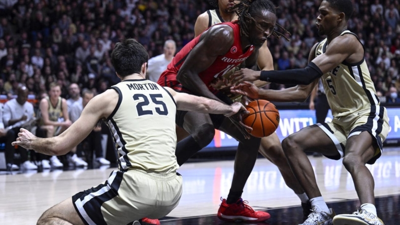 Jan 2, 2023; West Lafayette, Indiana, USA;  Rutgers Scarlet Knights center Clifford Omoruyi (11) attempts to keep the ball away from multiple Purdue Boilermakers during the first half at Mackey Arena. Mandatory Credit: Marc Lebryk-USA TODAY Sports