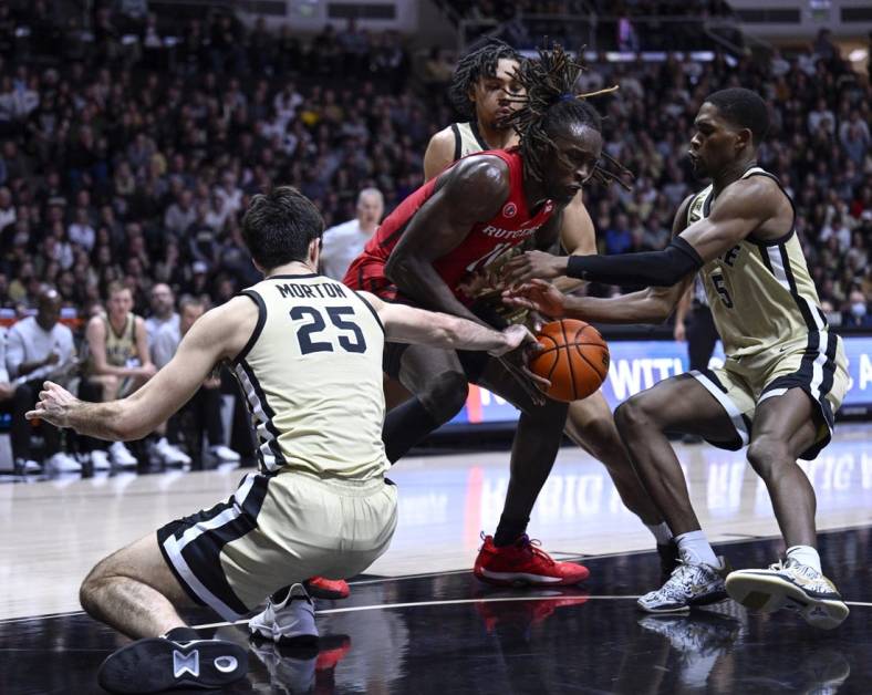 Jan 2, 2023; West Lafayette, Indiana, USA;  Rutgers Scarlet Knights center Clifford Omoruyi (11) attempts to keep the ball away from multiple Purdue Boilermakers during the first half at Mackey Arena. Mandatory Credit: Marc Lebryk-USA TODAY Sports
