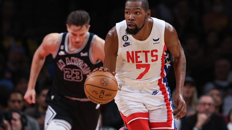 Jan 2, 2023; Brooklyn, New York, USA; Brooklyn Nets forward Kevin Durant (7) dribbles up court in front of San Antonio Spurs forward Zach Collins (23) during the first half at Barclays Center. Mandatory Credit: Vincent Carchietta-USA TODAY Sports