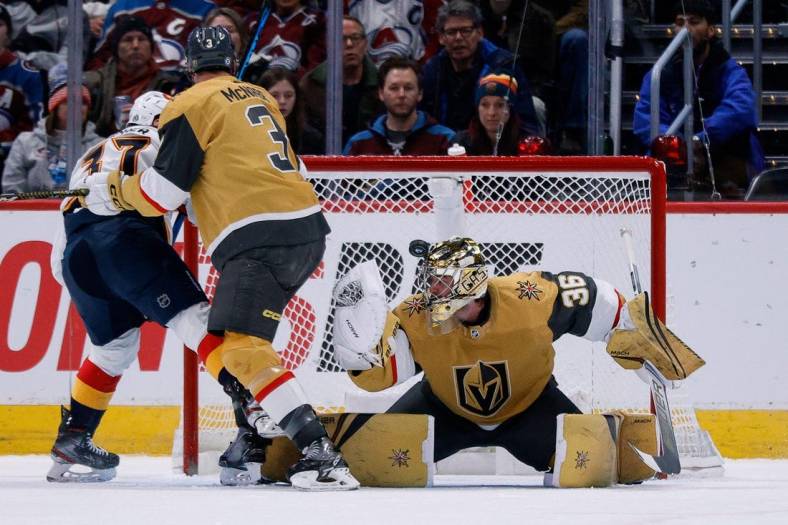Jan 2, 2023; Denver, Colorado, USA; The puck bounces off the helmet of Vegas Golden Knights goaltender Logan Thompson (36) as defenseman Brayden McNabb (3) and Colorado Avalanche left wing J.T. Compher (37) battle for position in the first period at Ball Arena. Mandatory Credit: Isaiah J. Downing-USA TODAY Sports