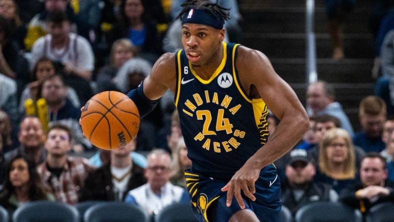 Jan 2, 2023; Indianapolis, Indiana, USA; Indiana Pacers guard Buddy Hield (24) dribbles the ball in the second quarter against the Toronto Raptors at Gainbridge Fieldhouse. Mandatory Credit: Trevor Ruszkowski-USA TODAY Sports