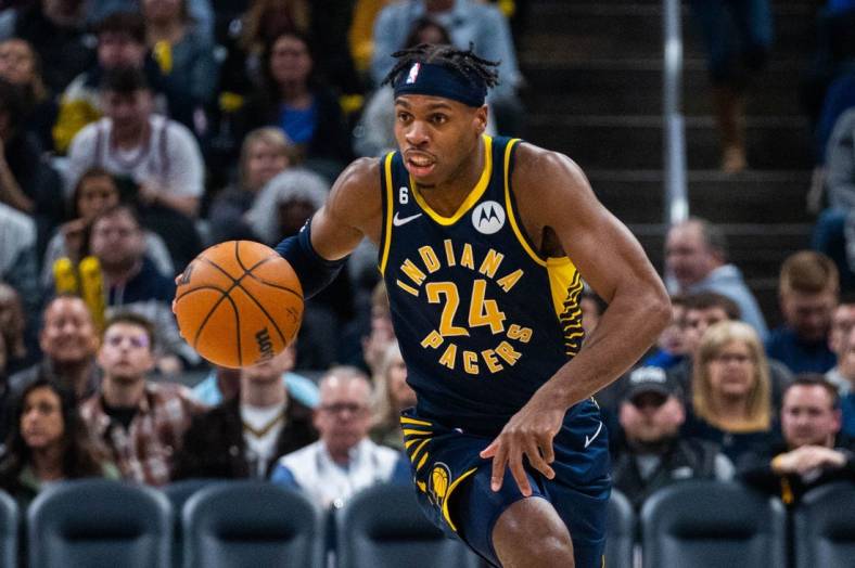 Jan 2, 2023; Indianapolis, Indiana, USA; Indiana Pacers guard Buddy Hield (24) dribbles the ball in the second quarter against the Toronto Raptors at Gainbridge Fieldhouse. Mandatory Credit: Trevor Ruszkowski-USA TODAY Sports