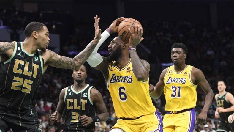 Jan 2, 2023; Charlotte, North Carolina, USA; Los Angeles Lakers forward LeBron James (6) looks to shoot as he is defended by Charlotte Hornets forward P.J. Washington (25) during second half at the Spectrum Center. Mandatory Credit: Sam Sharpe-USA TODAY Sports