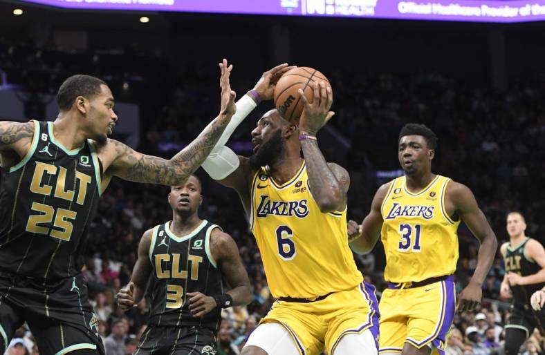 Jan 2, 2023; Charlotte, North Carolina, USA; Los Angeles Lakers forward LeBron James (6) looks to shoot as he is defended by Charlotte Hornets forward P.J. Washington (25) during second half at the Spectrum Center. Mandatory Credit: Sam Sharpe-USA TODAY Sports