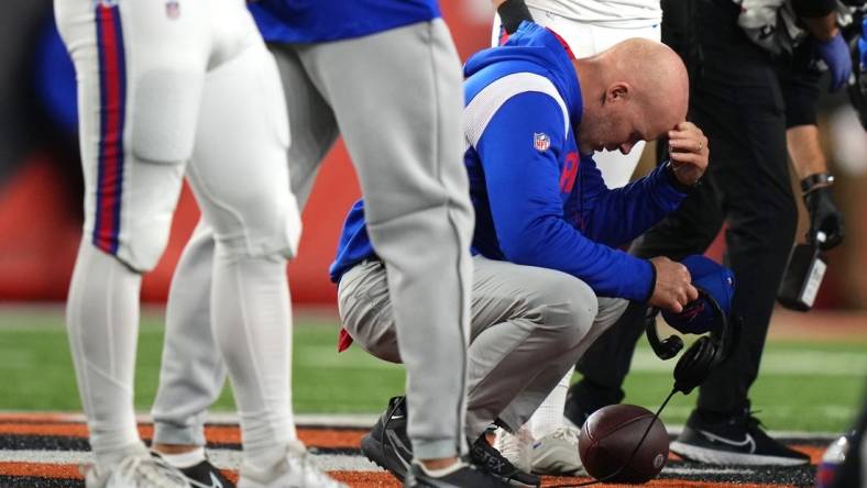 Jan 2, 2023; Cincinnati, Ohio, USA; Buffalo Bills head coach Sean McDermott takes a knee is as Buffalo Bills safety Damar Hamlin (3) is tended to on the field following a collision in the first quarter against the Cincinnati Bengals at Paycor Stadium. Mandatory Credit: Kareem Elgazzar-USA TODAY Sports