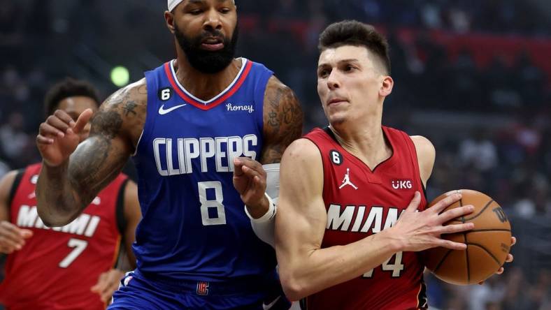 Jan 2, 2023; Los Angeles, California, USA;  Miami Heat guard Tyler Herro (14) drives to the basket against Los Angeles Clippers forward Marcus Morris Sr. (8) during the first quarter at Crypto.com Arena. Mandatory Credit: Kiyoshi Mio-USA TODAY Sports