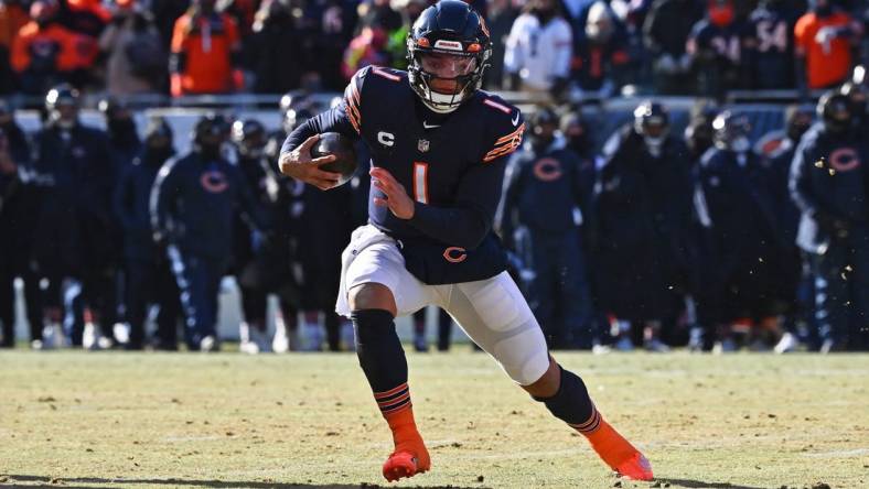 Dec 24, 2022; Chicago, Illinois, USA;  Chicago Bears quarterback Justin Fields (1) runs with the ball against the Buffalo Bills at Soldier Field. Mandatory Credit: Jamie Sabau-USA TODAY Sports