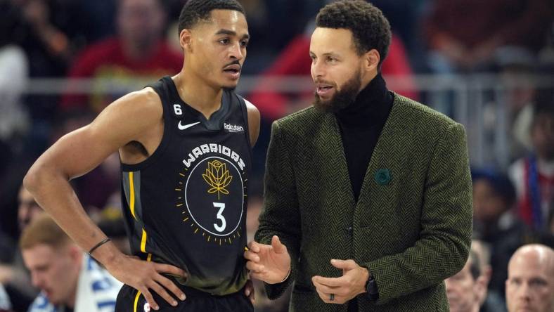 Dec 25, 2022; San Francisco, California, USA; Golden State Warriors guard Stephen Curry (right) talks to guard Jordan Poole (3) during the first quarter against the Memphis Grizzlies at Chase Center. Mandatory Credit: Darren Yamashita-USA TODAY Sports