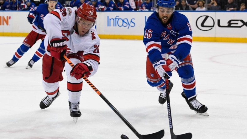 Jan 3, 2023; New York, New York, USA; Carolina Hurricanes center Paul Stastny (26) andNew York Rangers center Vincent Trocheck (16) battle for a loose puck during the first period at Madison Square Garden. Mandatory Credit: Dennis Schneidler-USA TODAY Sports