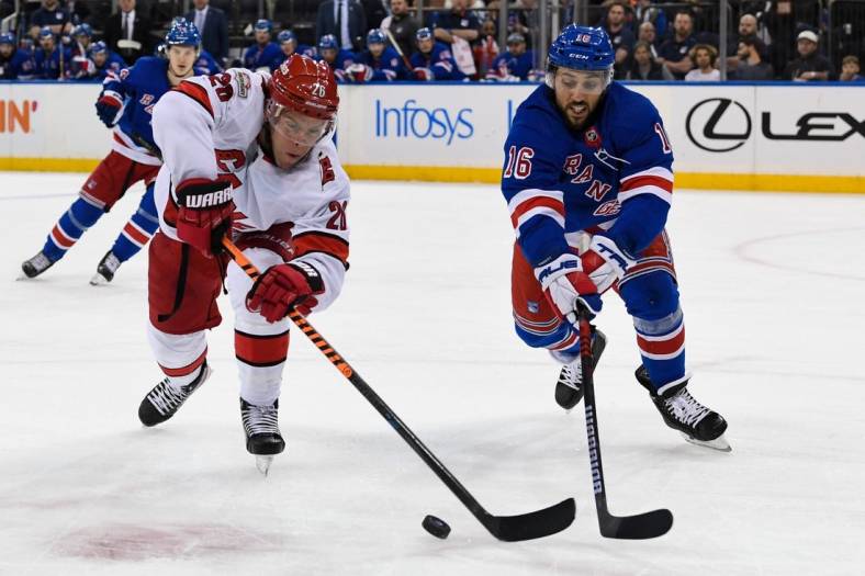 Jan 3, 2023; New York, New York, USA; Carolina Hurricanes center Paul Stastny (26) andNew York Rangers center Vincent Trocheck (16) battle for a loose puck during the first period at Madison Square Garden. Mandatory Credit: Dennis Schneidler-USA TODAY Sports