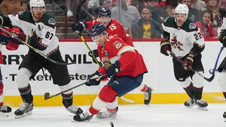 Jan 3, 2023; Sunrise, Florida, USA;  Florida Panthers center Sam Reinhart (13) battles for possession against the Arizona Coyotes during the first period at FLA Live Arena. Mandatory Credit: Jim Rassol-USA TODAY Sports