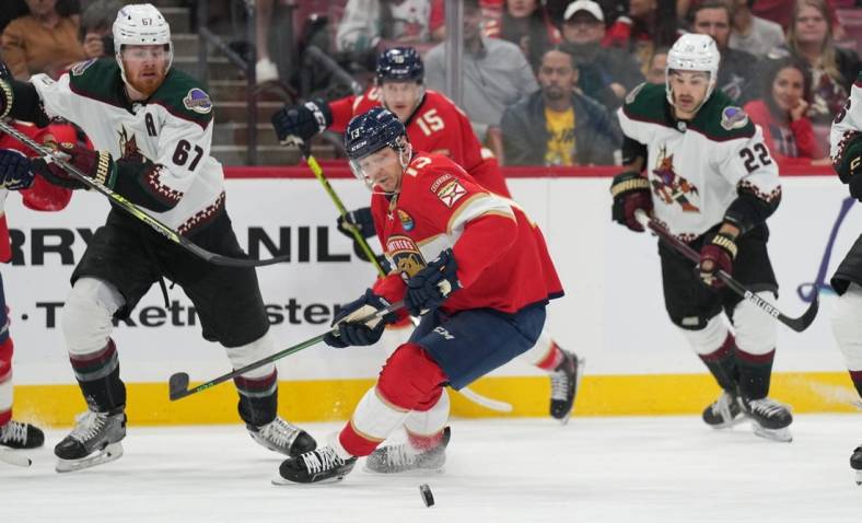 Jan 3, 2023; Sunrise, Florida, USA;  Florida Panthers center Sam Reinhart (13) battles for possession against the Arizona Coyotes during the first period at FLA Live Arena. Mandatory Credit: Jim Rassol-USA TODAY Sports