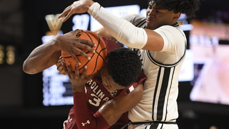 Jan 3, 2023; Nashville, Tennessee, USA; South Carolina Gamecocks forward Gregory Jackson II (23) and Vanderbilt Commodores guard Tyrin Lawrence (0) fight for the loose ball during the second half at Memorial Gymnasium. Mandatory Credit: Steve Roberts-USA TODAY Sports