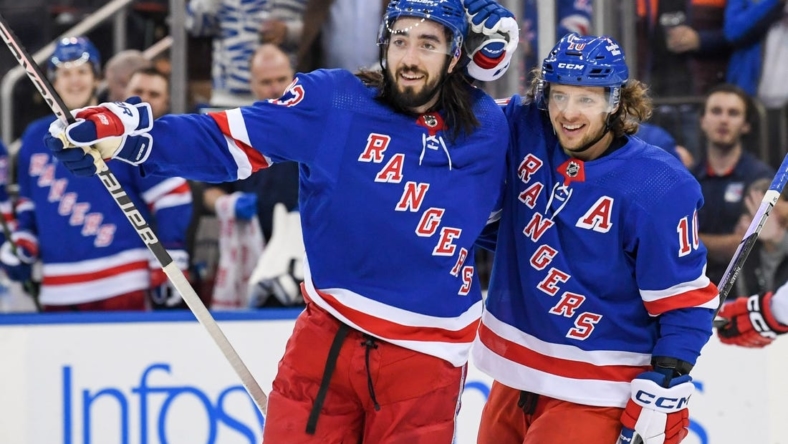 Jan 3, 2023; New York, New York, USA; New York Rangers left wing Artemi Panarin (10) celebrates the goal by New York Rangers center Mika Zibanejad (93) against the Carolina Hurricanes during the second period at Madison Square Garden. Mandatory Credit: Dennis Schneidler-USA TODAY Sports