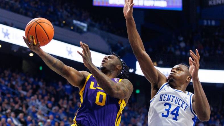 Jan 3, 2023; Lexington, Kentucky, USA; LSU Tigers guard Trae Hannibal (0) goes to the basket against Kentucky Wildcats forward Oscar Tshiebwe (34) during the first half at Rupp Arena at Central Bank Center. Mandatory Credit: Jordan Prather-USA TODAY Sports