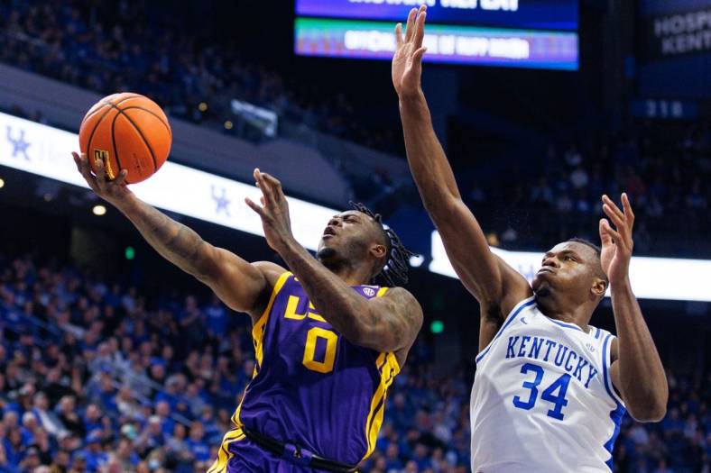Jan 3, 2023; Lexington, Kentucky, USA; LSU Tigers guard Trae Hannibal (0) goes to the basket against Kentucky Wildcats forward Oscar Tshiebwe (34) during the first half at Rupp Arena at Central Bank Center. Mandatory Credit: Jordan Prather-USA TODAY Sports