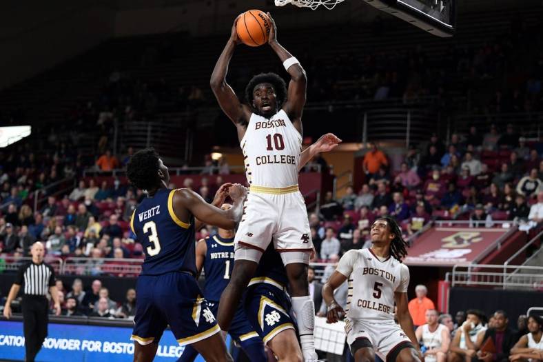 Jan 3, 2023; Chestnut Hill, Massachusetts, USA; Boston College Eagles guard Prince Aligbe (10) comes down with a rebound  during the second half against the Notre Dame Fighting Irish at Conte Forum. Mandatory Credit: Eric Canha-USA TODAY Sports