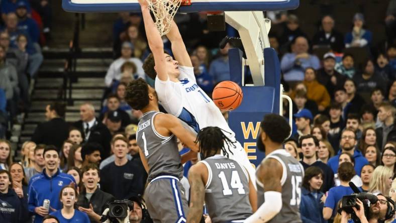 Jan 3, 2023; Omaha, Nebraska, USA; Creighton Bluejays center Ryan Kalkbrenner (11) dunks over Seton Hall Pirates forward Tray Jackson (1) in the first half at CHI Health Center Omaha. Mandatory Credit: Steven Branscombe-USA TODAY Sports