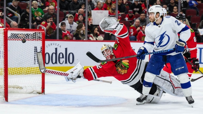 Jan 3, 2023; Chicago, Illinois, USA; Chicago Blackhawks goaltender Alex Stalock (32) dives after a shot as Tampa Bay Lightning center Brayden Point (21) screens during the second period at the United Center. Mandatory Credit: Daniel Bartel-USA TODAY Sports