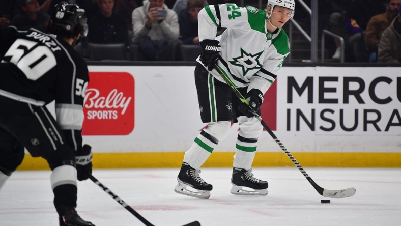 Jan 3, 2023; Los Angeles, California, USA; Dallas Stars center Roope Hintz (24) controls the puck against Los Angeles Kings defenseman Sean Durzi (50) during the first period at Crypto.com Arena. Mandatory Credit: Gary A. Vasquez-USA TODAY Sports