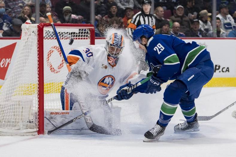 Jan 3, 2023; Vancouver, British Columbia, CAN; New York Islanders goalie Ilya Sorokin (30) makes a save on Vancouver Canucks forward Lane Pederson (29) in the first period at Rogers Arena. Mandatory Credit: Bob Frid-USA TODAY Sports