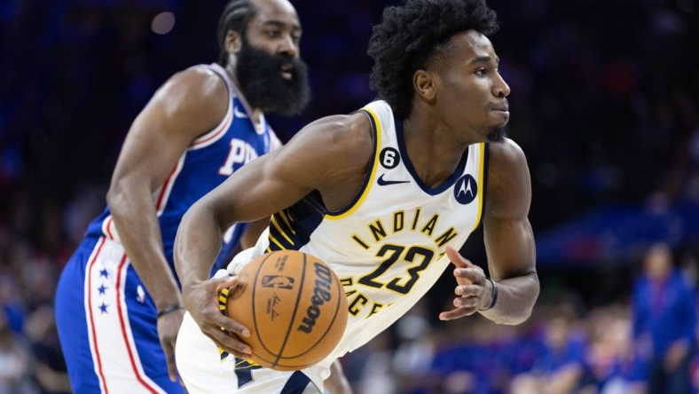 Jan 4, 2023; Philadelphia, Pennsylvania, USA; Indiana Pacers forward Aaron Nesmith (23) dribbles with the ball in front of Philadelphia 76ers guard James Harden (1) during the second quarter at Wells Fargo Center. Mandatory Credit: Bill Streicher-USA TODAY Sports