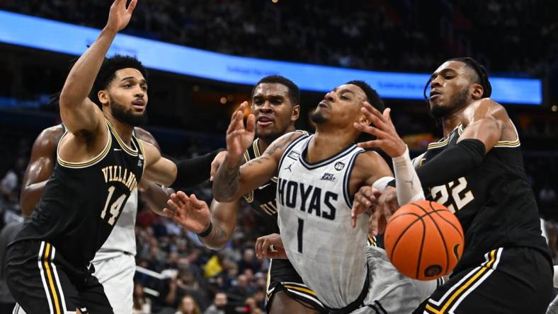 Jan 4, 2023; Washington, District of Columbia, USA; Georgetown Hoyas guard Primo Spears (1) is fouled by Villanova Wildcats forward Cam Whitmore (22) during the second half at Capital One Arena. Mandatory Credit: Brad Mills-USA TODAY Sports