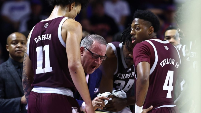 Jan 4, 2023; Gainesville, Florida, USA; Texas A&M Aggies head coach Buzz Williams talks with forward Andersson Garcia (11) and guard Wade Taylor IV (4) against the Florida Gators  during the second half at Exactech Arena at the Stephen C. O'Connell Center. Mandatory Credit: Kim Klement-USA TODAY Sports