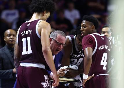 Jan 4, 2023; Gainesville, Florida, USA; Texas A&M Aggies head coach Buzz Williams talks with forward Andersson Garcia (11) and guard Wade Taylor IV (4) against the Florida Gators  during the second half at Exactech Arena at the Stephen C. O'Connell Center. Mandatory Credit: Kim Klement-USA TODAY Sports