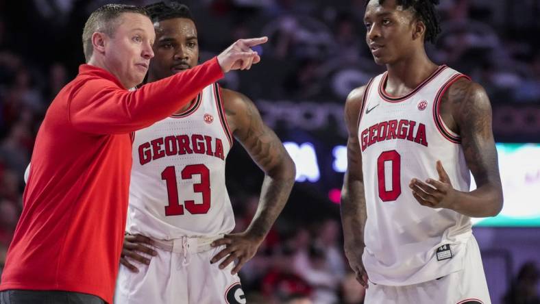 Jan 4, 2023; Athens, Georgia, USA; Georgia Bulldogs head coach Mike White coaches guards Mardrez McBride (13) and Terry Roberts (0) against the Auburn Tigers during the second half at Stegeman Coliseum. Mandatory Credit: Dale Zanine-USA TODAY Sports