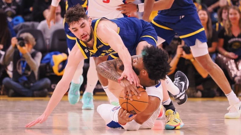 Jan 4, 2023; San Francisco, California, USA; Golden State Warriors shooting guard Ty Jerome (10) extends for the ball against Detroit Pistons small forward Saddiq Bey (41) on the floor during the second quarter at Chase Center. Mandatory Credit: Kelley L Cox-USA TODAY Sports