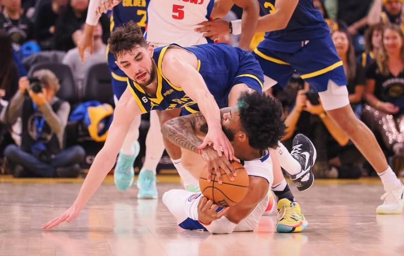 Jan 4, 2023; San Francisco, California, USA; Golden State Warriors shooting guard Ty Jerome (10) extends for the ball against Detroit Pistons small forward Saddiq Bey (41) on the floor during the second quarter at Chase Center. Mandatory Credit: Kelley L Cox-USA TODAY Sports