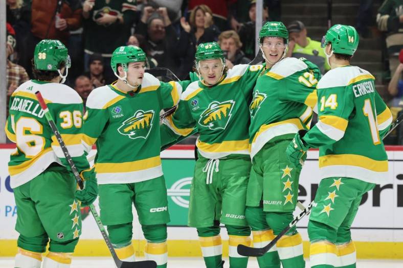Jan 4, 2023; Saint Paul, Minnesota, USA; Minnesota Wild left wing Kirill Kaprizov (97) celebrates his goal with teammates during the second period against the Tampa Bay Lightning at Xcel Energy Center. Mandatory Credit: Bruce Fedyck-USA TODAY Sports