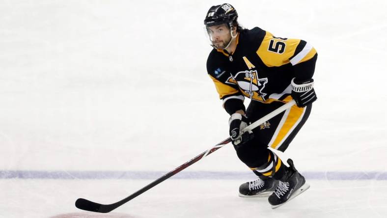 Dec 28, 2022; Pittsburgh, Pennsylvania, USA;  Pittsburgh Penguins defenseman Kris Letang (58) skates with the puck against the Detroit Red Wings during the second period at PPG Paints Arena. Mandatory Credit: Charles LeClaire-USA TODAY Sports