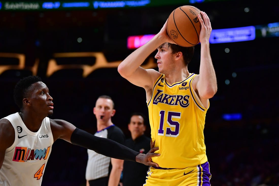 Jan 4, 2023; Los Angeles, California, USA; Los Angeles Lakers guard Austin Reaves (15) controls the ball against Miami Heat guard Victor Oladipo (4) during the second half at Crypto.com Arena. Mandatory Credit: Gary A. Vasquez-USA TODAY Sports