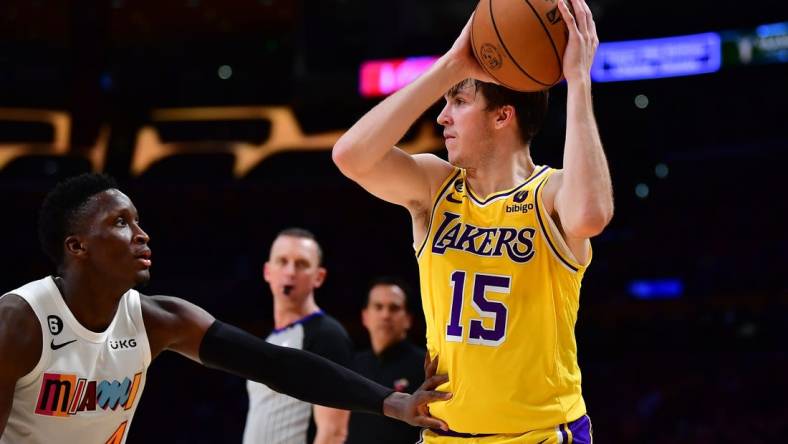 Jan 4, 2023; Los Angeles, California, USA; Los Angeles Lakers guard Austin Reaves (15) controls the ball against Miami Heat guard Victor Oladipo (4) during the second half at Crypto.com Arena. Mandatory Credit: Gary A. Vasquez-USA TODAY Sports