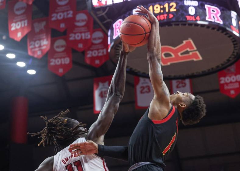 Jan 5, 2023; Piscataway, New Jersey, USA; Rutgers Scarlet Knights center Clifford Omoruyi (11) blocks a shot by Maryland Terrapins guard Jahmir Young (1) during the first half at Jersey Mike's Arena. Mandatory Credit: Vincent Carchietta-USA TODAY Sports