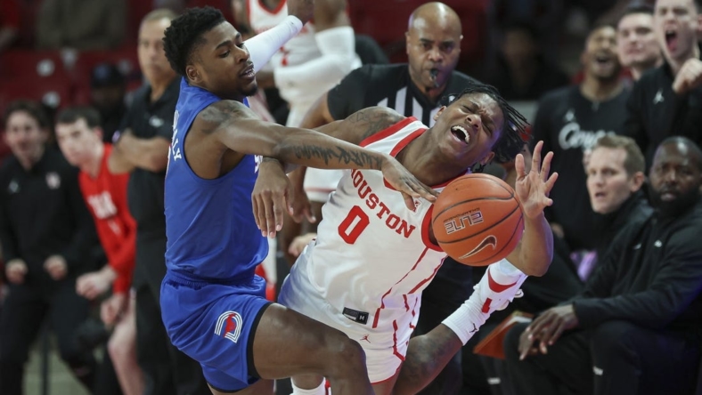 Jan 5, 2023; Houston, Texas, USA; Southern Methodist Mustangs guard Jefferson Koulibaly (0) and Houston Cougars guard Marcus Sasser (0) battle for the ball during the first half at Fertitta Center. Mandatory Credit: Troy Taormina-USA TODAY Sports