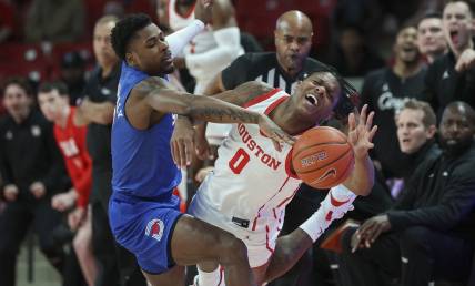 Jan 5, 2023; Houston, Texas, USA; Southern Methodist Mustangs guard Jefferson Koulibaly (0) and Houston Cougars guard Marcus Sasser (0) battle for the ball during the first half at Fertitta Center. Mandatory Credit: Troy Taormina-USA TODAY Sports