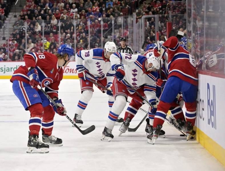 Jan 5, 2023; Montreal, Quebec, CAN; New York Rangers forward Filip Chytil (72) and Montreal Canadiens defenseman Mike Matheson (8) try to get the puck moving along the boards during the first period at the Bell Centre. Mandatory Credit: Eric Bolte-USA TODAY Sports
