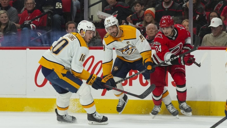 Jan 5, 2023; Raleigh, North Carolina, USA;  Nashville Predators center Colton Sissons (10) and defenseman Roman Josi (59) watch the puck against Carolina Hurricanes center Seth Jarvis (24) during the first period at PNC Arena. Mandatory Credit: James Guillory-USA TODAY Sports
