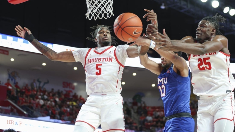 Jan 5, 2023; Houston, Texas, USA; Houston Cougars forward Ja'Vier Francis (5) and forward Jarace Walker (25) attempt to get the ball away from Southern Methodist Mustangs center Mo Njie (13) during the second half at Fertitta Center. Mandatory Credit: Troy Taormina-USA TODAY Sports