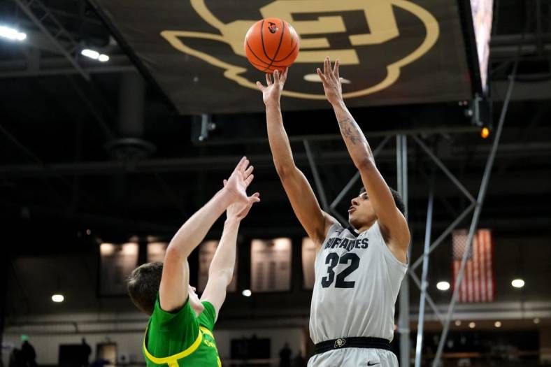 Jan 5, 2023; Boulder, Colorado, USA; Colorado Buffaloes guard Nique Clifford (32) shoots over Oregon Ducks guard Brennan Rigsby (4) in the first half at the CU Events Center. Mandatory Credit: Ron Chenoy-USA TODAY Sports
